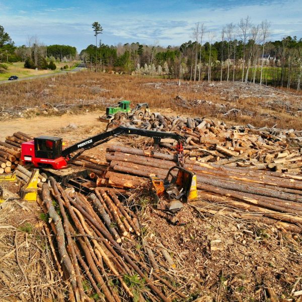 red and black heavy equipment on brown soil